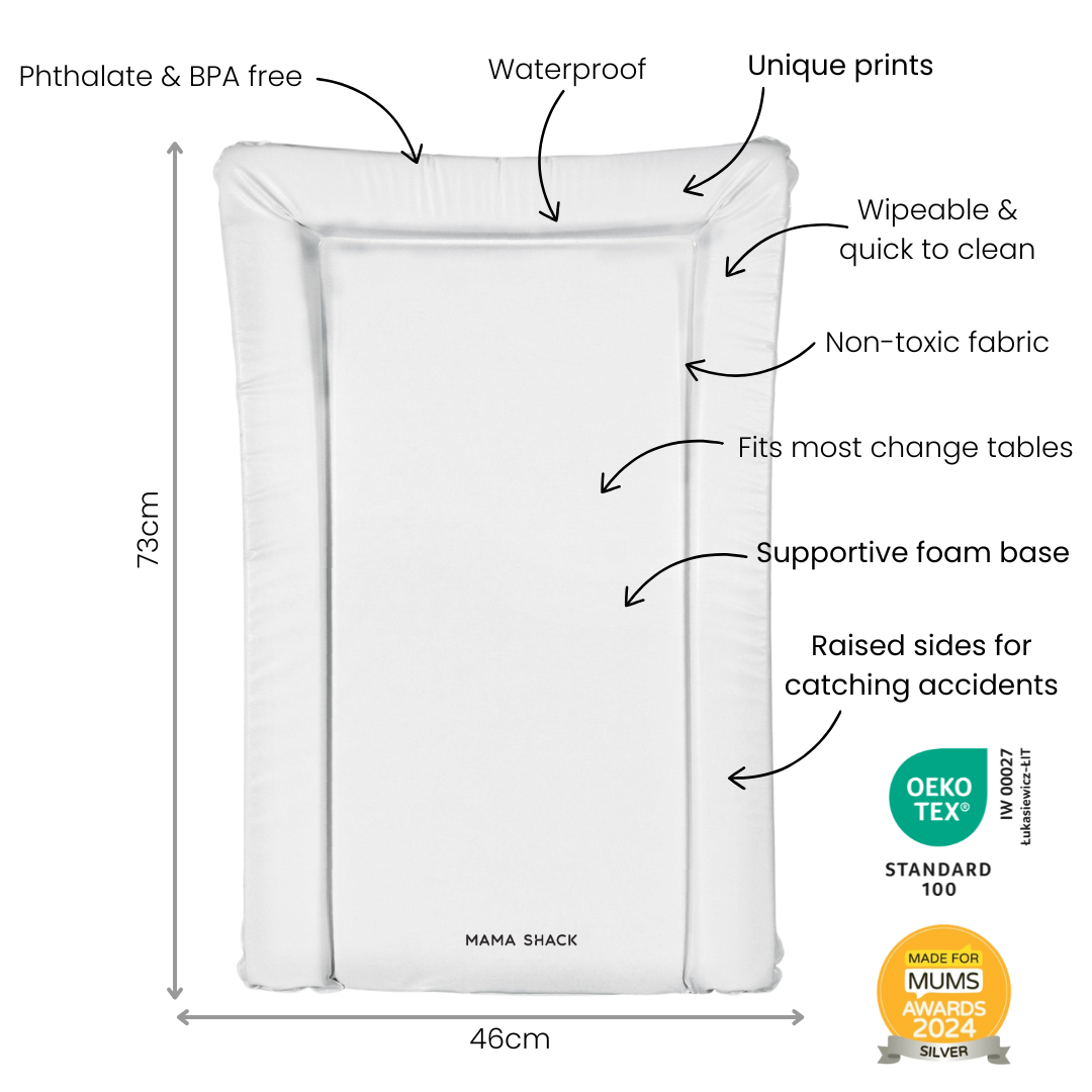 Baby's nursery with a crib, wall decorations, and a sage green changing mat