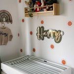 Baby's nursery with a crib, wall decorations, and a sage green changing mat