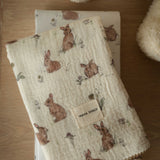 Folded fabric with rabbit pattern on a wooden surface