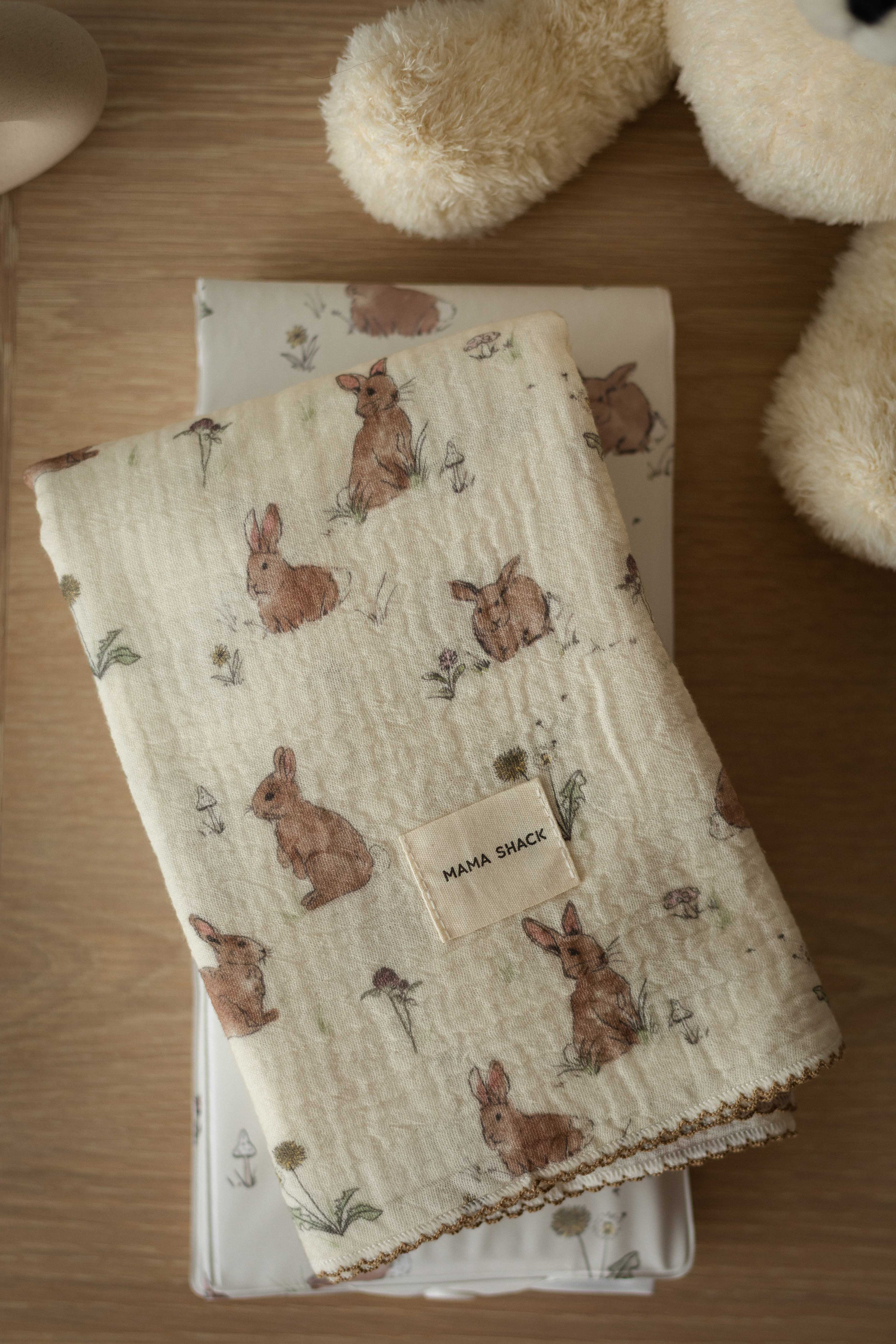 Folded fabric with rabbit pattern on a wooden surface