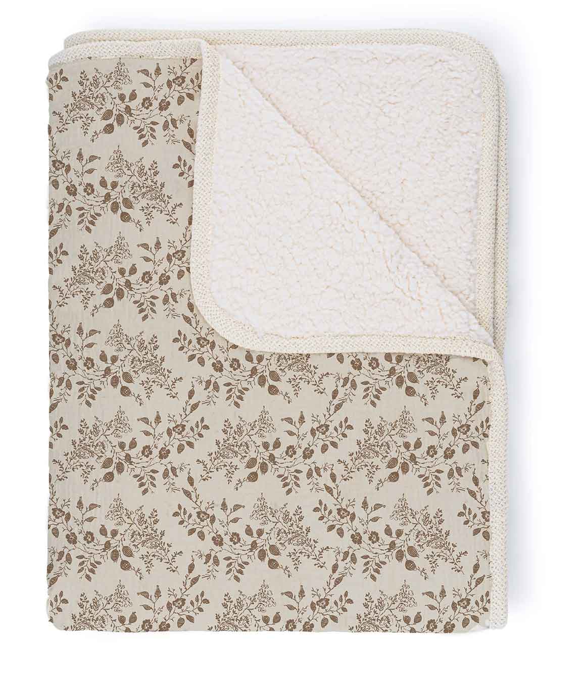 Floral patterned blanket with textured border on a white background